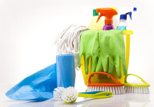 Technician applying safe chemical handling practices during carpet cleaning